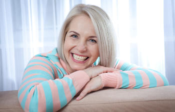 older woman smiling to the camera